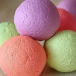 DIY Play Dough – A Fun, Easy, and Mess-Free Craft for Kids 3 Pastel-colored mochi ice cream balls stacked on a light wooden surface