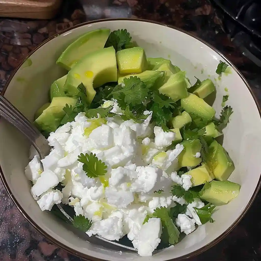 High Protein Cottage Cheese Avocado Salad 4 Bowl of fresh avocado, cucumber, feta cheese, and cilantro salad