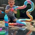 Rainbow Bubble Snakes – Magical Foam Monsters for Outdoor Play 3 Child enjoying a colorful rainbow foam eruption outdoors during a science activity