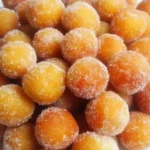 Best Homemade Puff Puff – A Sweet, Golden West African Delight 3 A pile of golden brown mini donuts covered in sugar crystals