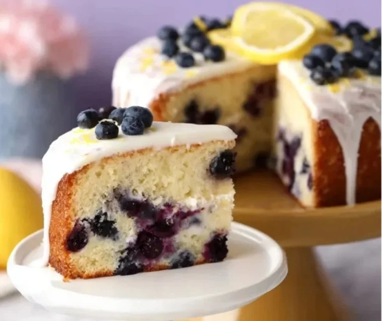 Lemon Blueberry Cake 2 Delicious Lemon Blueberry Cake topped with fresh blueberries and lemon zest.