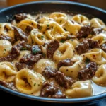 Cheesesteak tortellini served in rich provolone sauce