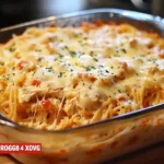 Creamy Rotel chicken spaghetti casserole with toppings in a baking dish