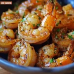 Plate of Hawaiian Garlic Shrimp with garlic sauce and herbs