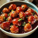 Delicious sweet and sour meatballs served with vibrant sauce and garnishes
