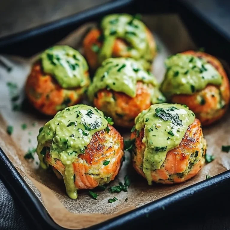 Baked salmon balls served with creamy avocado sauce on a plate